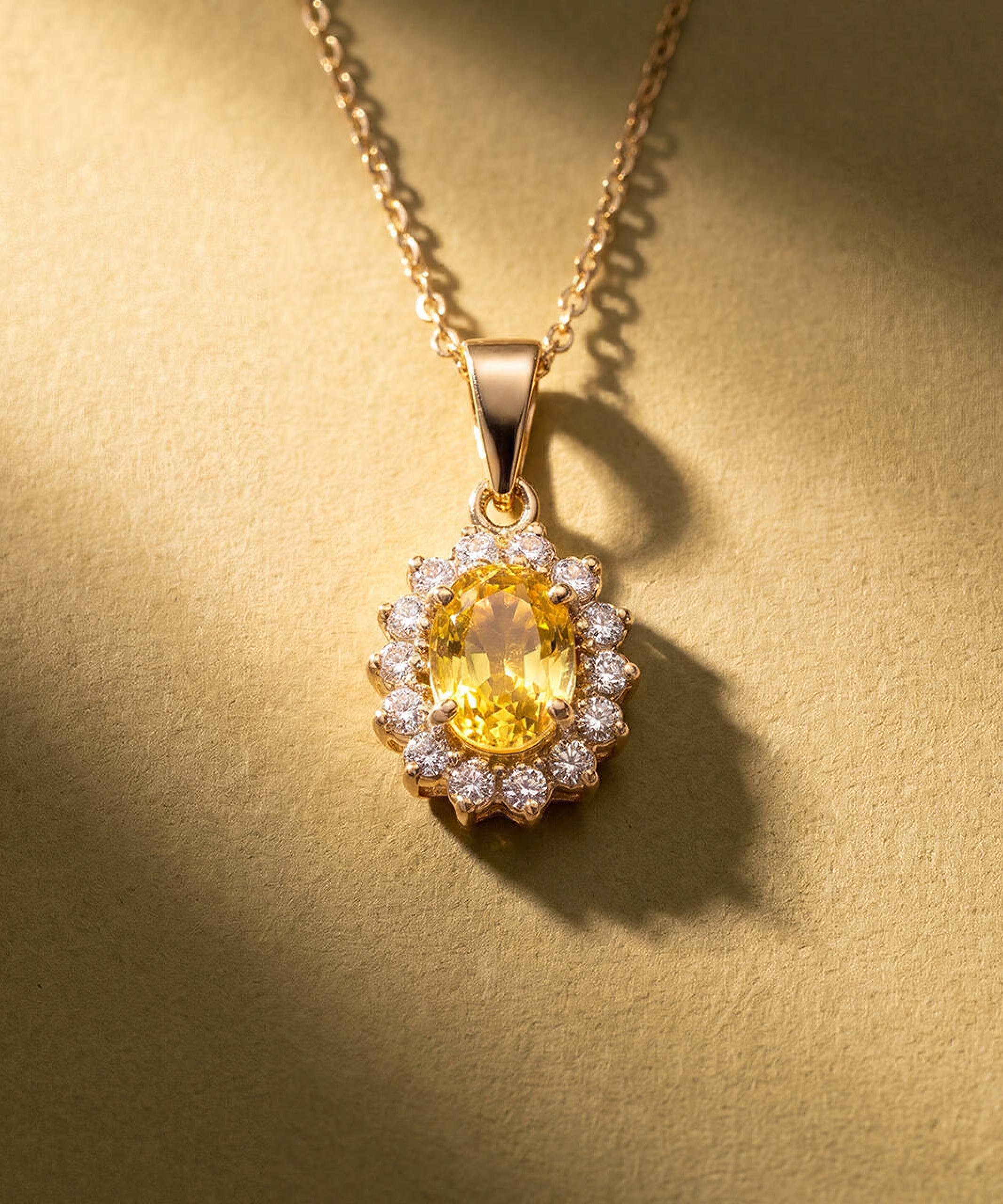Vintage jewellery collection featuring a yellow sapphire and diamond pendant in yellow gold.