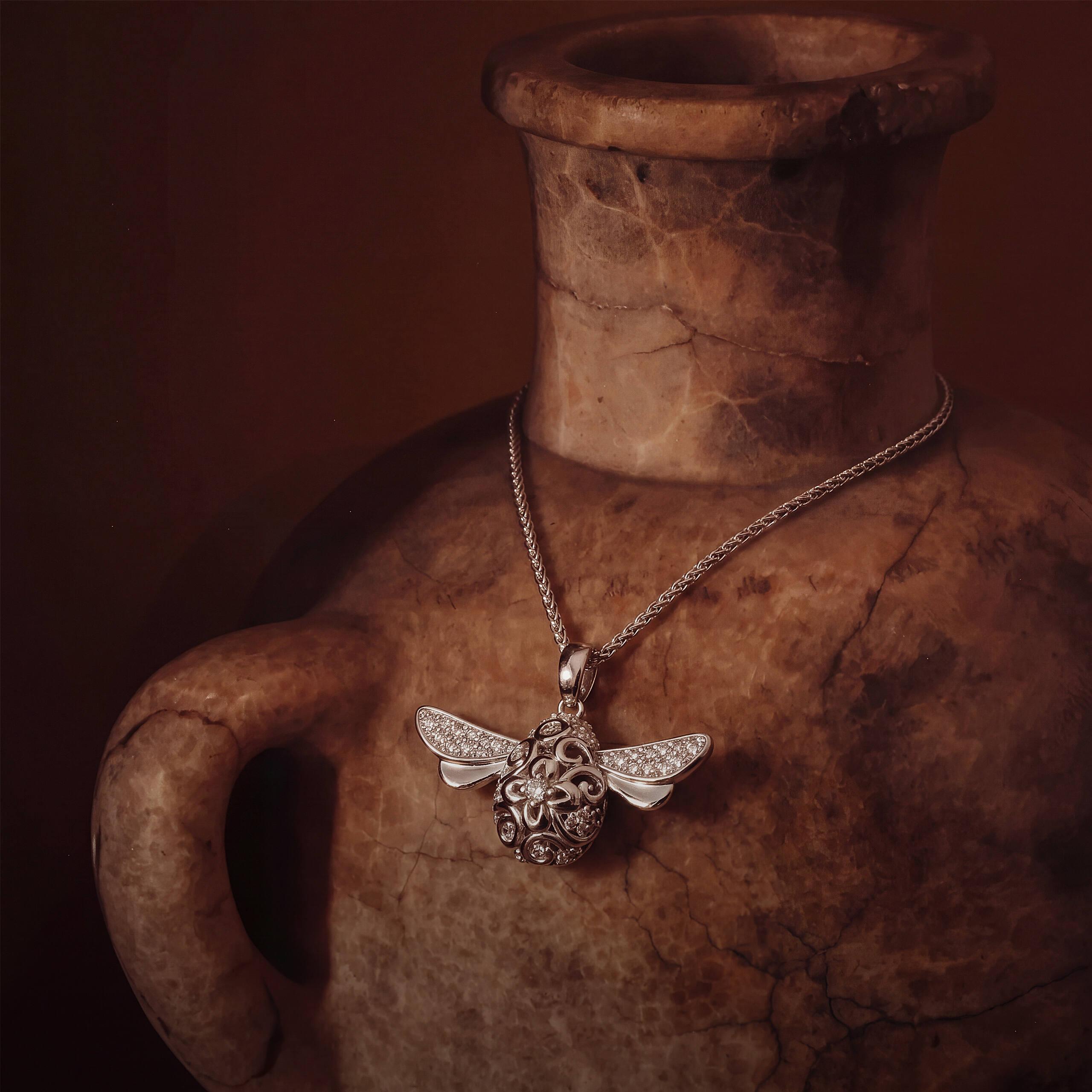 Modern pendant necklace styled on a ceramic vase