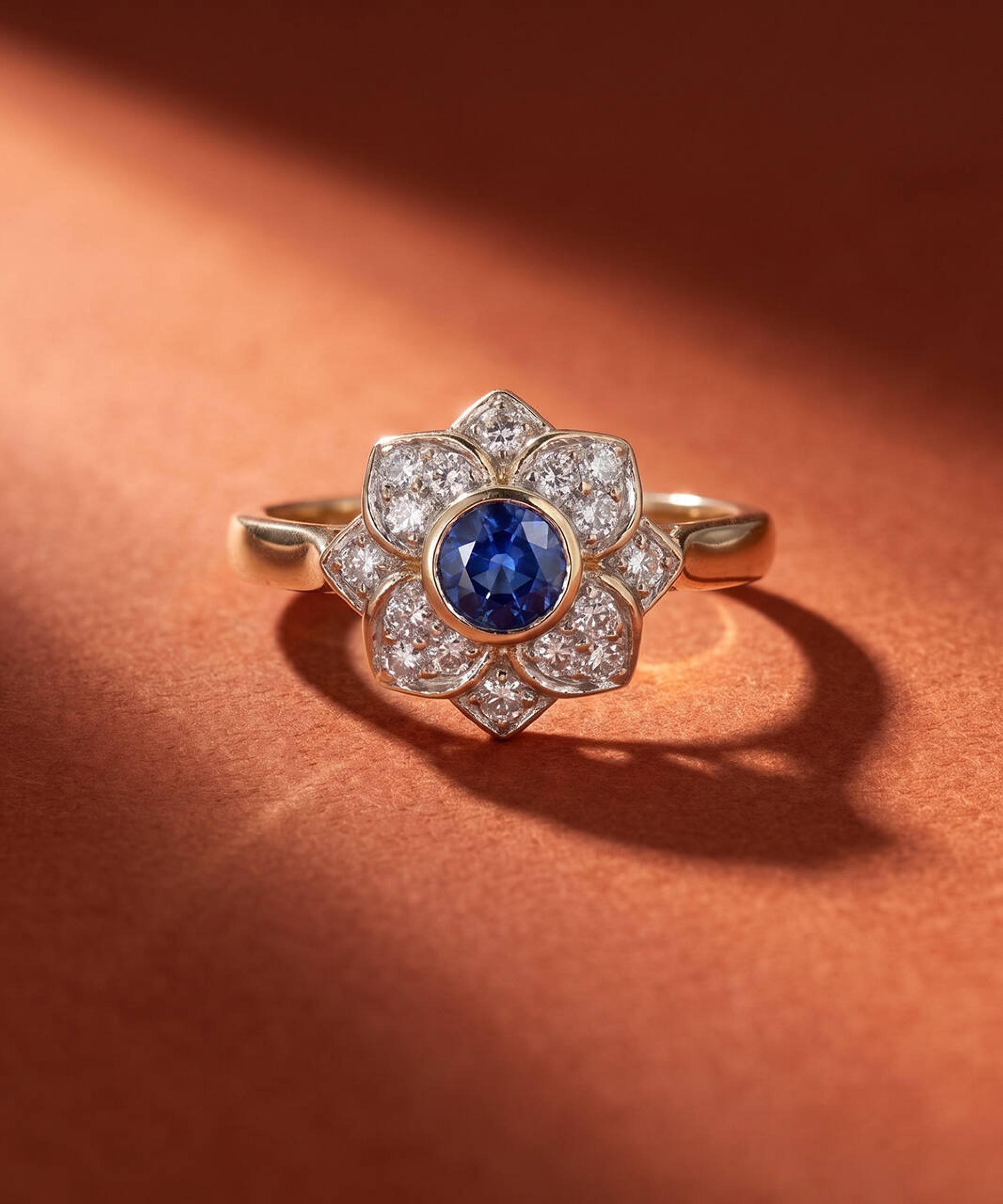 Vintage jewellery collection featuring a sapphire and diamond flower ring in yellow gold